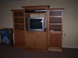 Built wood entertainment center with shelves and cabinets