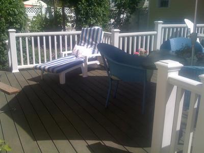 Deck with white railings and patio furniture